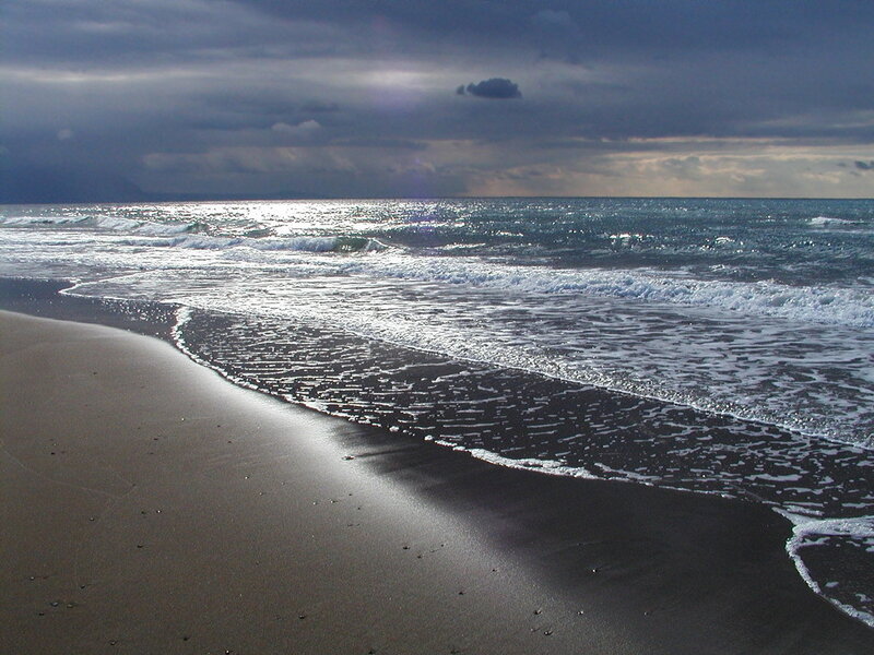 Dark beach under stormy sky