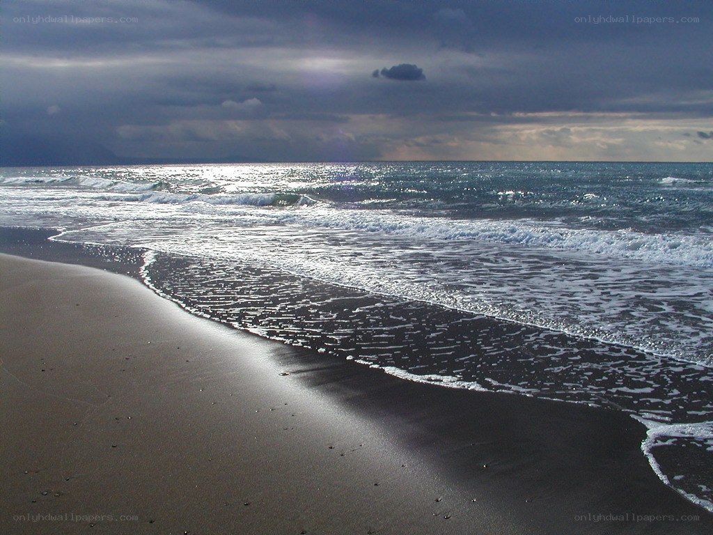 Dark beach under stormy sky