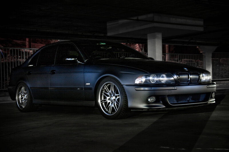 dark blue bmw in parking garage