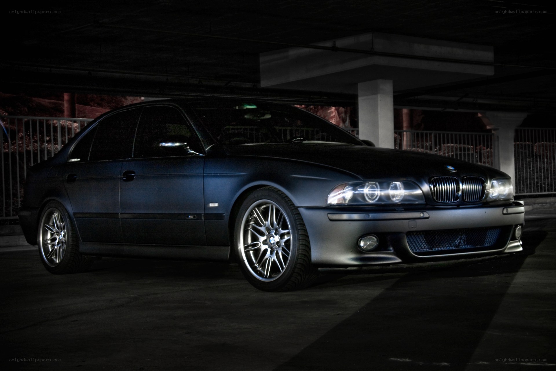 dark blue bmw in parking garage