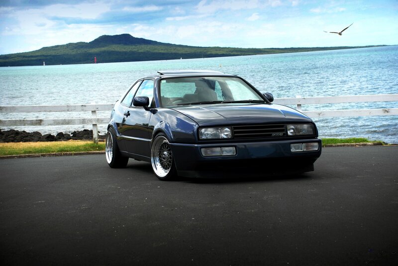 Dark blue car by the sea