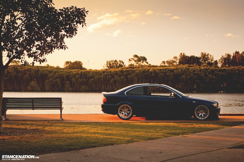 Dark blue coupe by the lake