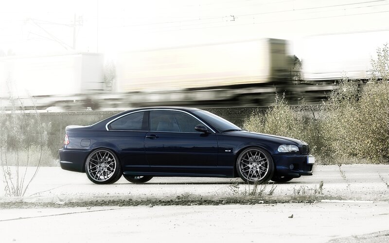 dark blue coupe on roadside