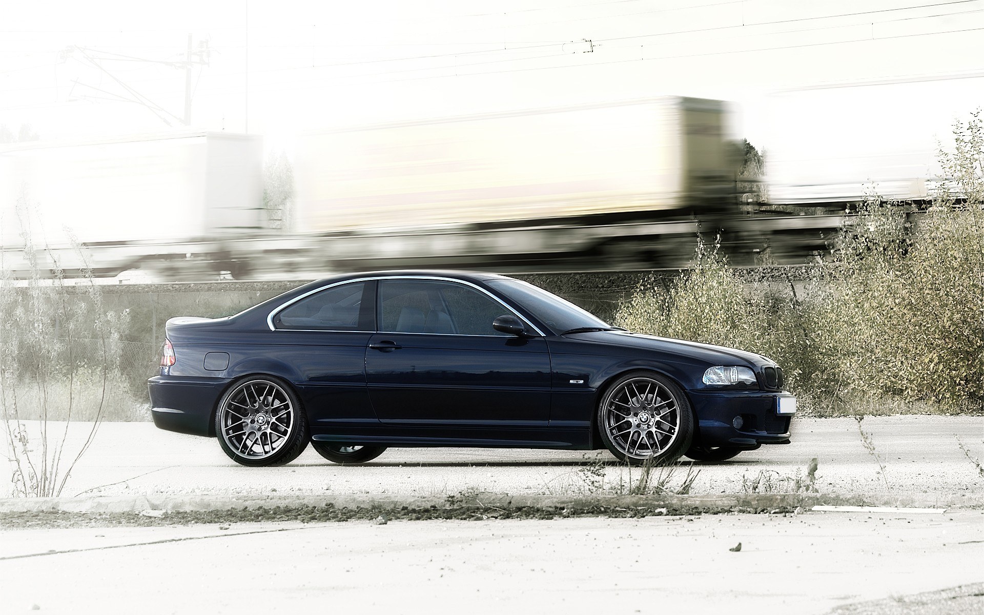 dark blue coupe on roadside