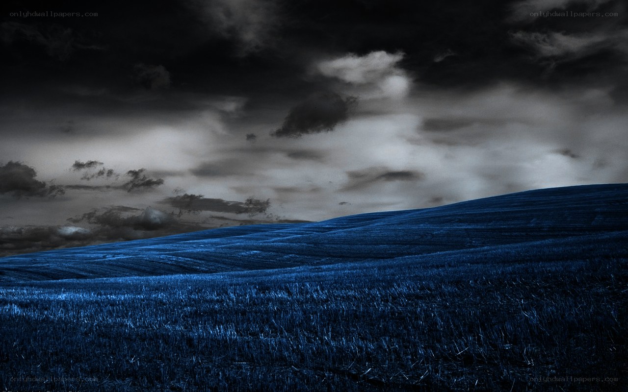 Dark blue field under stormy sky