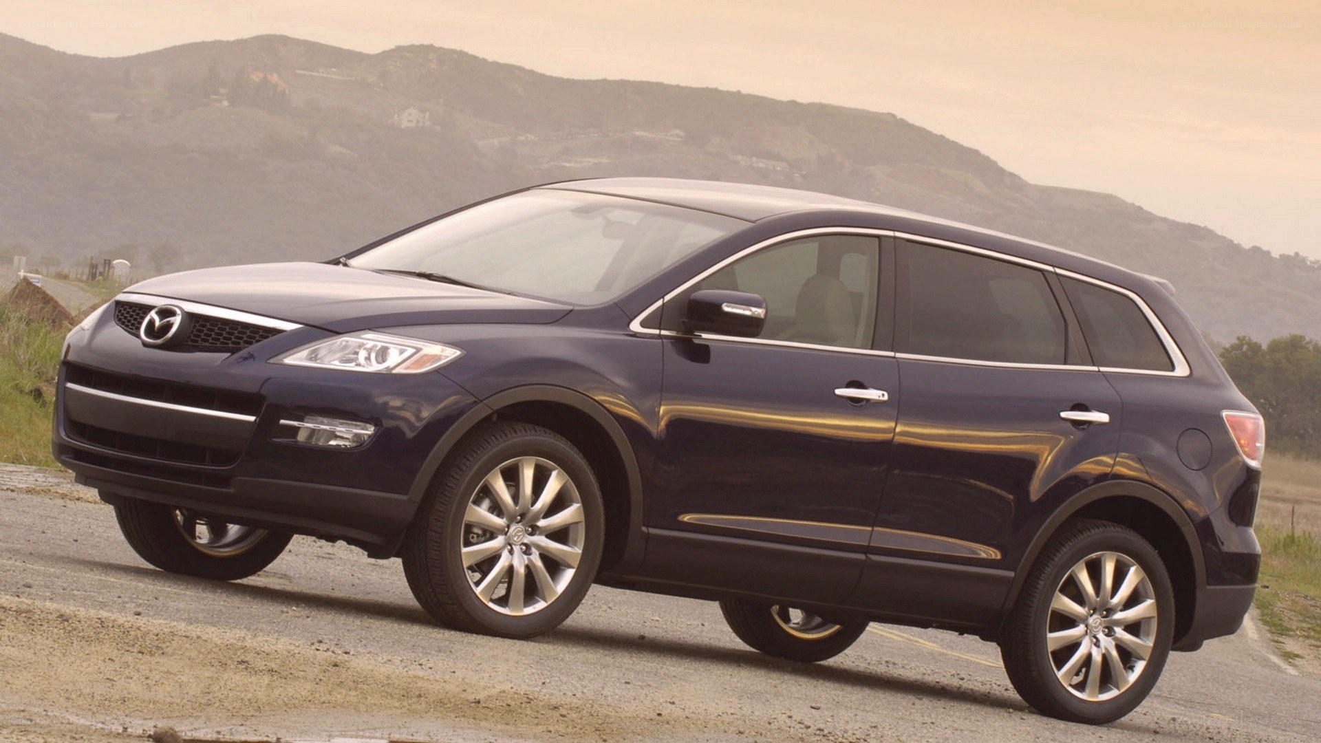 dark blue mazda suv on road