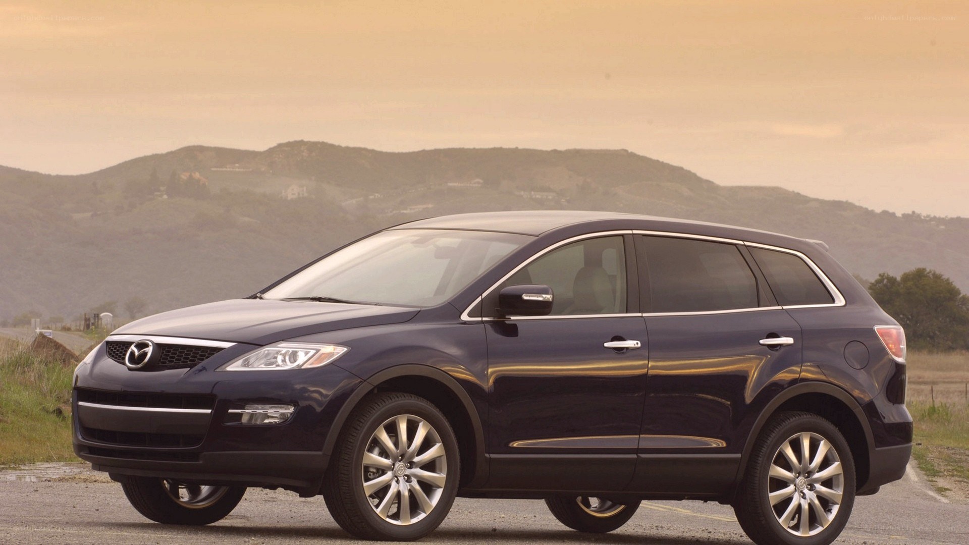 dark blue mazda suv on road