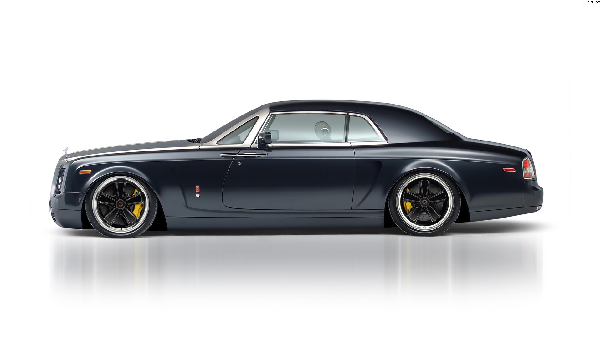 dark blue rolls-royce coupe