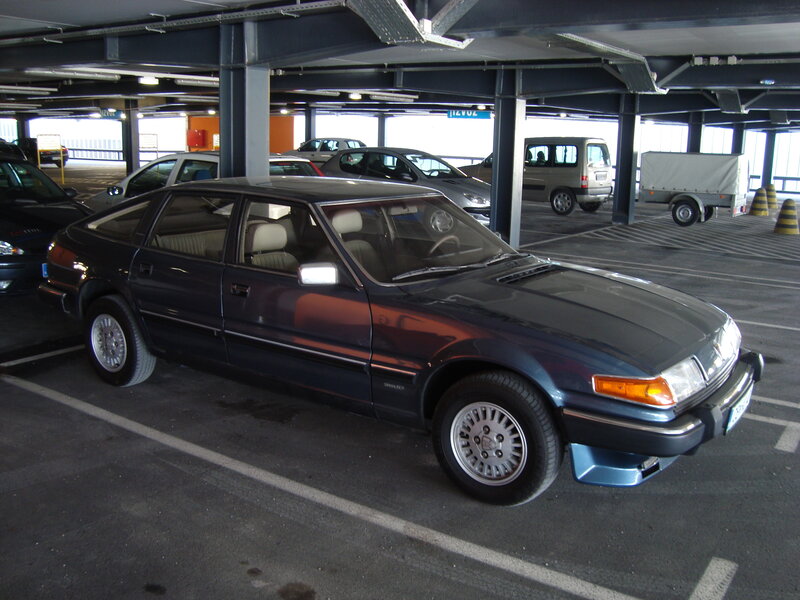 Dark blue sedan in parking garage