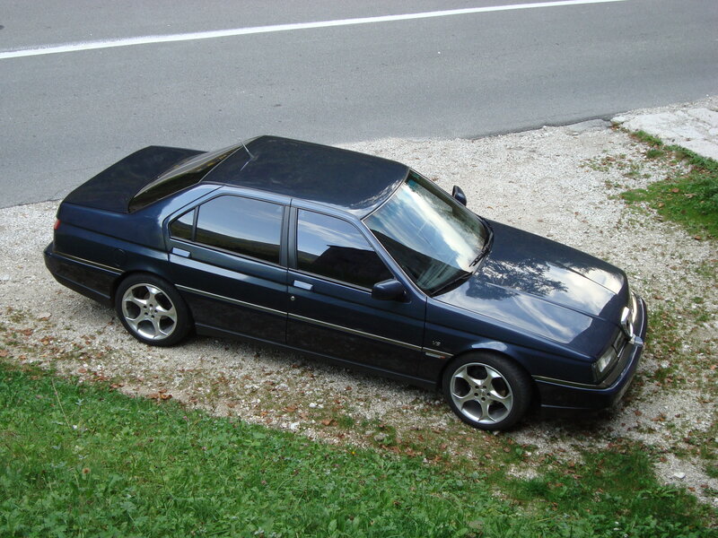 dark blue sedan on gravel