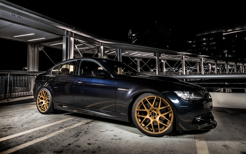 dark blue sedan with gold wheels