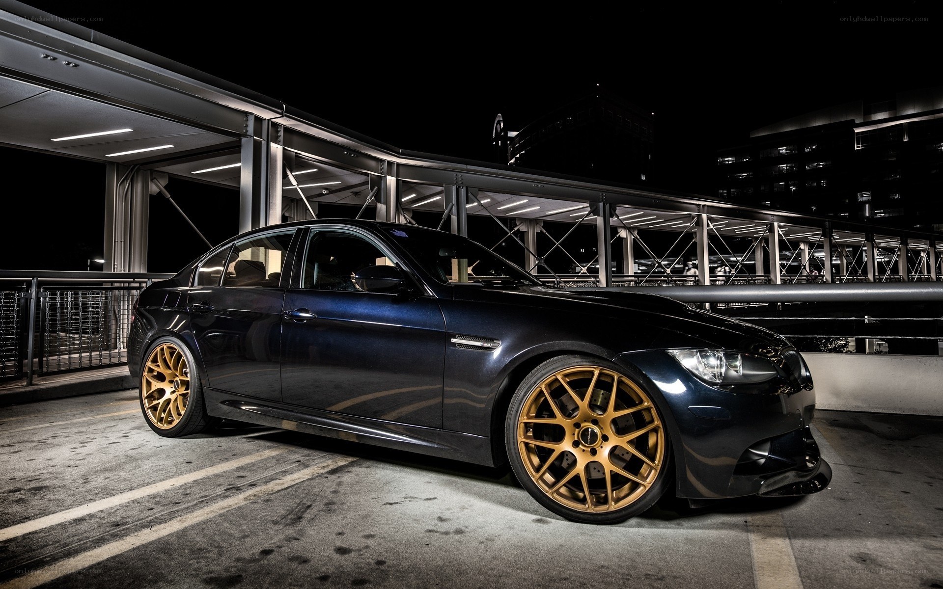 dark blue sedan with gold wheels