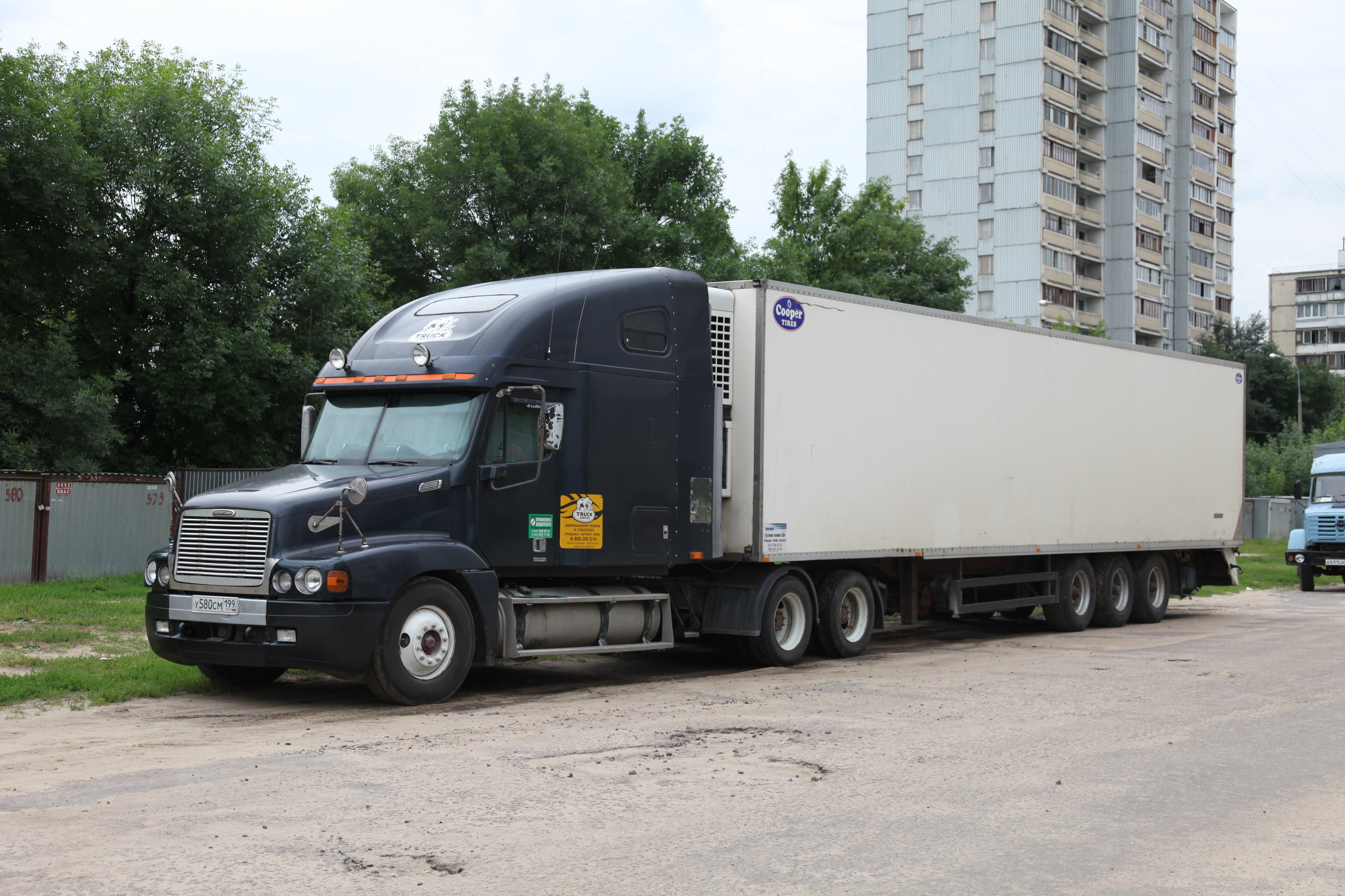 Dark blue semi-truck with trailer