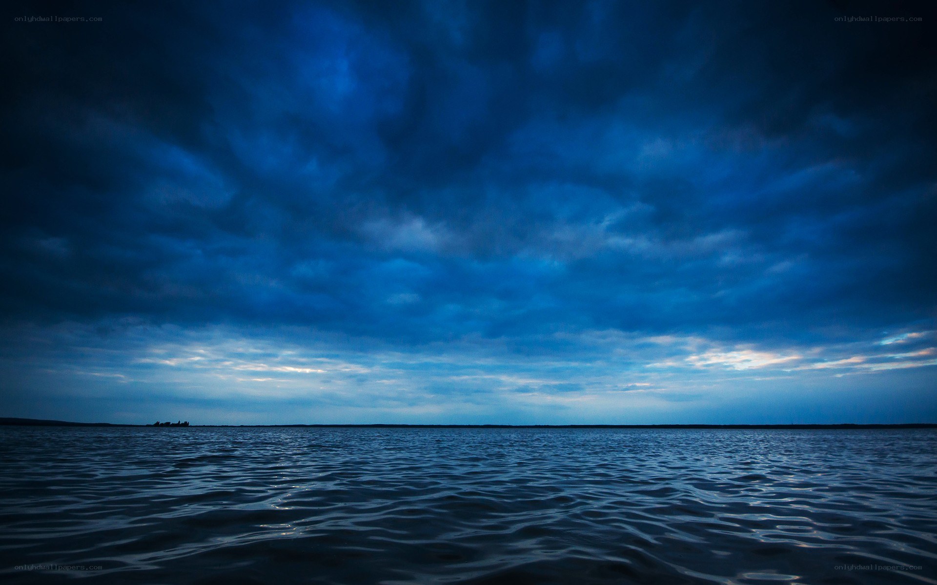 Dark blue sky over calm water