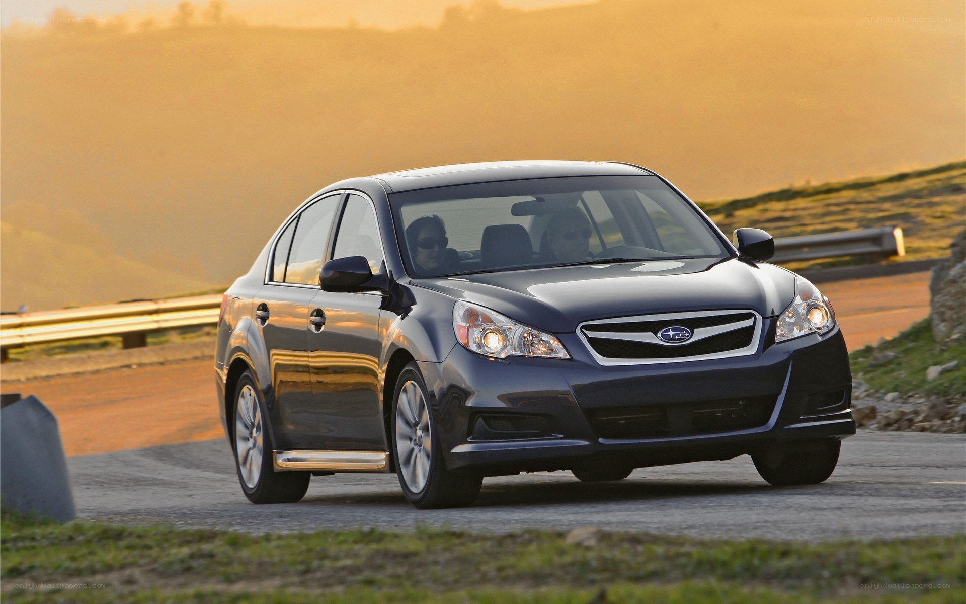 dark blue subaru sedan on road
