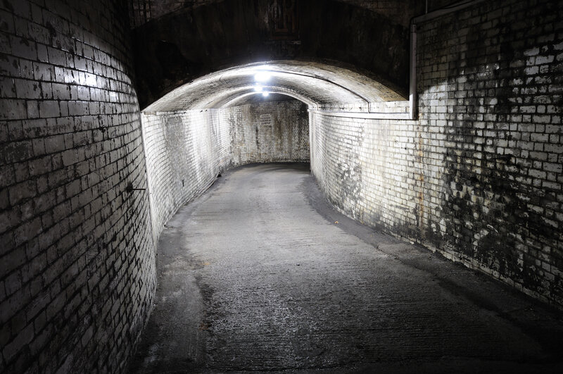 dark brick tunnel corridor
