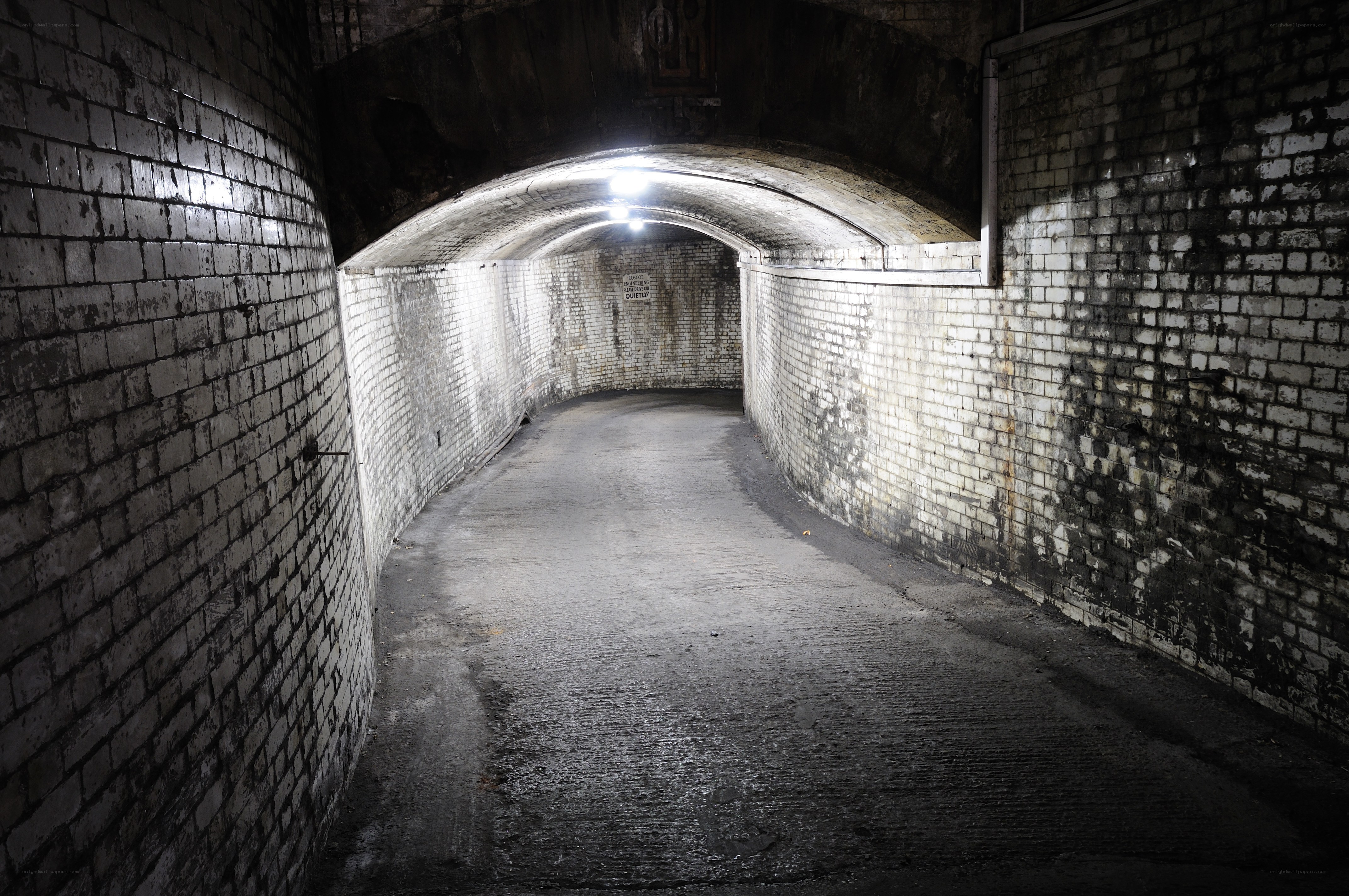 dark brick tunnel corridor