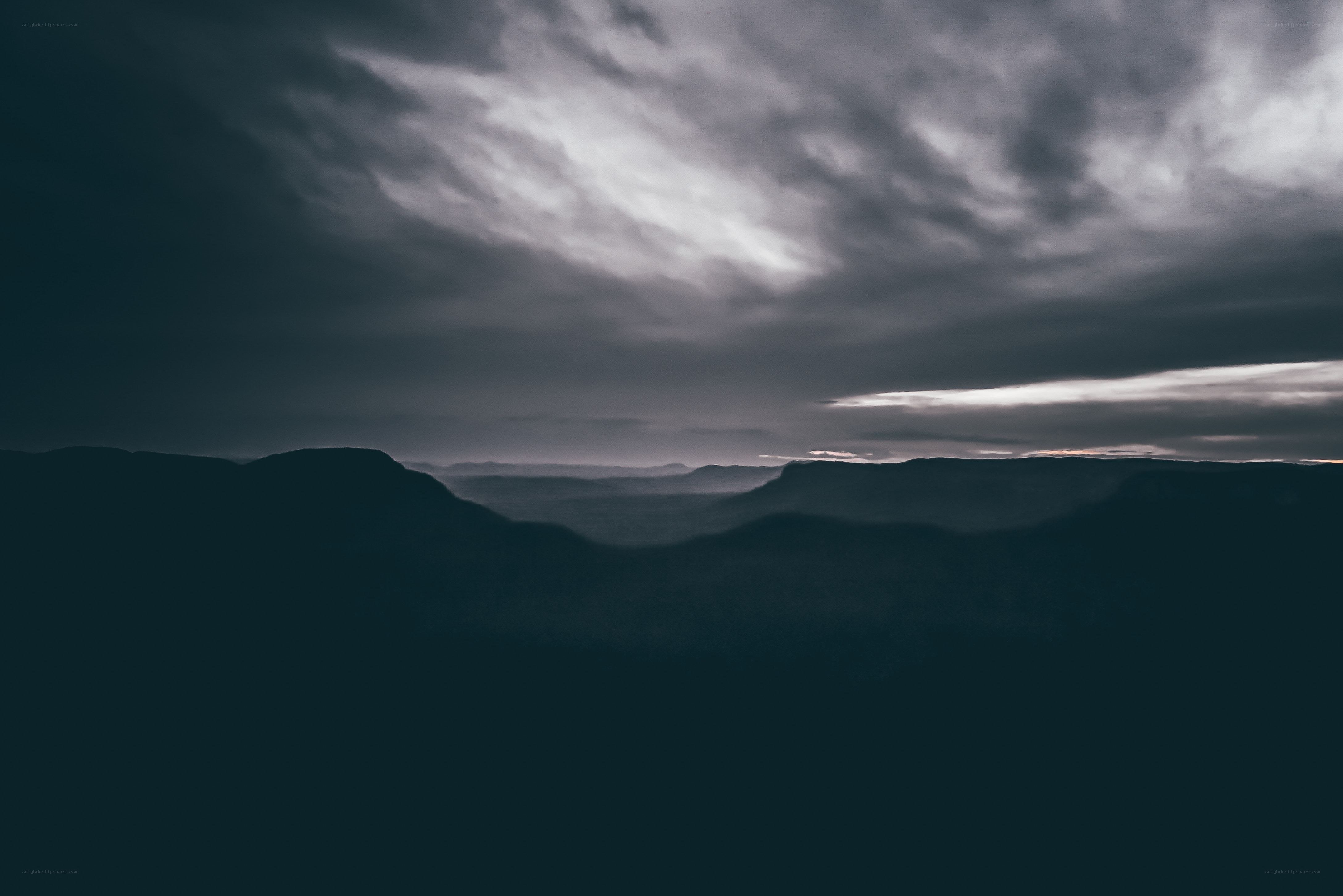 Dark canyon under stormy sky
