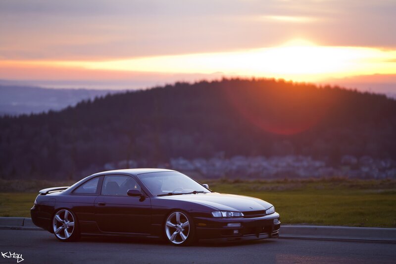 Dark car at sunset on a hill
