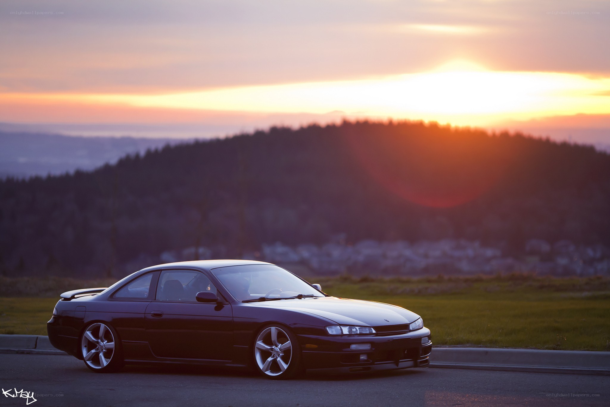 Dark car at sunset on a hill
