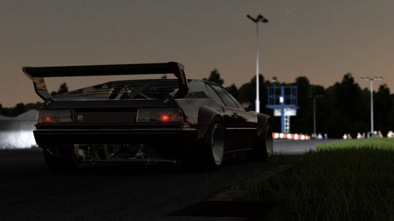 dark car on racetrack at dusk