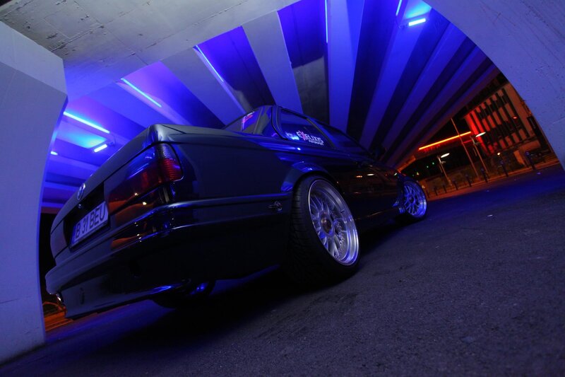 Dark car under blue lights