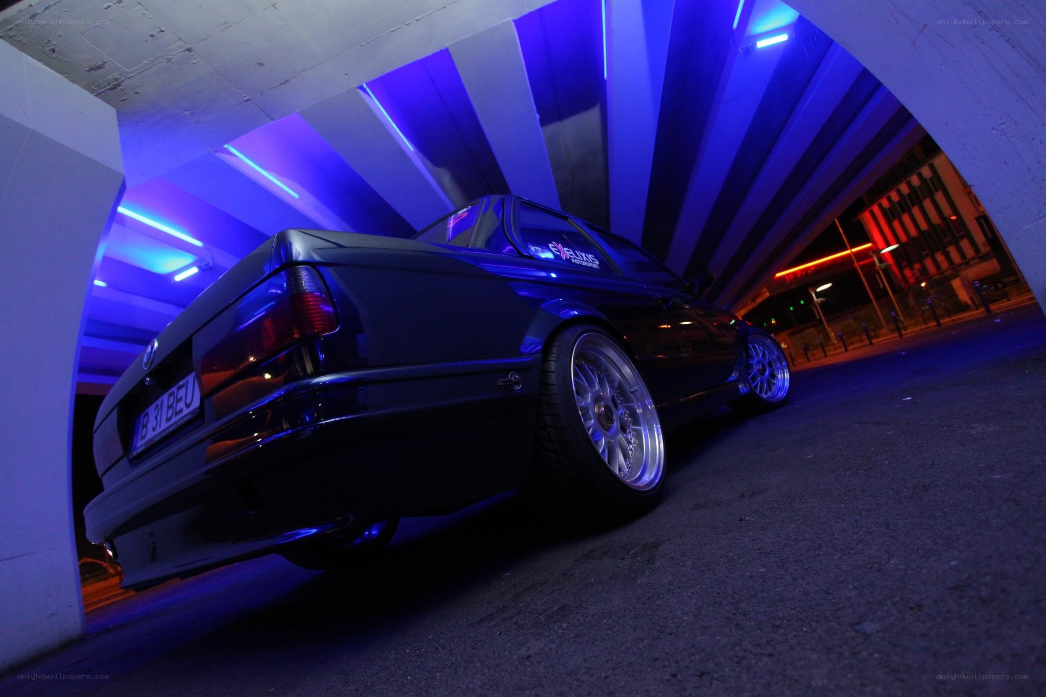 Dark car under blue lights