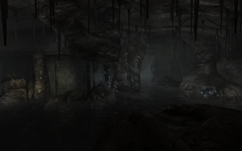 dark cave with water and stalactites