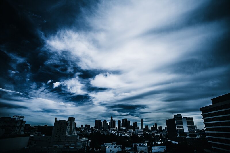 dark city skyline under stormy sky