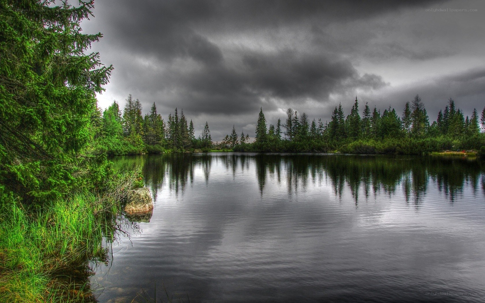 Dark clouds over a forest lake