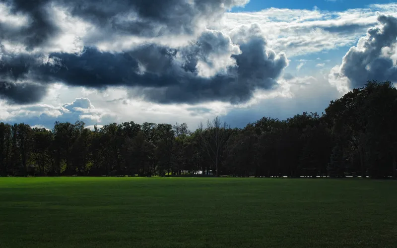 Dark clouds over a green field