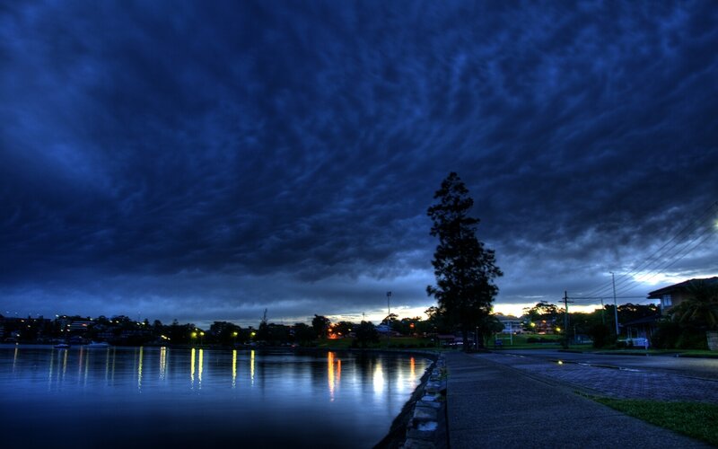 Dark clouds over a lakeside town