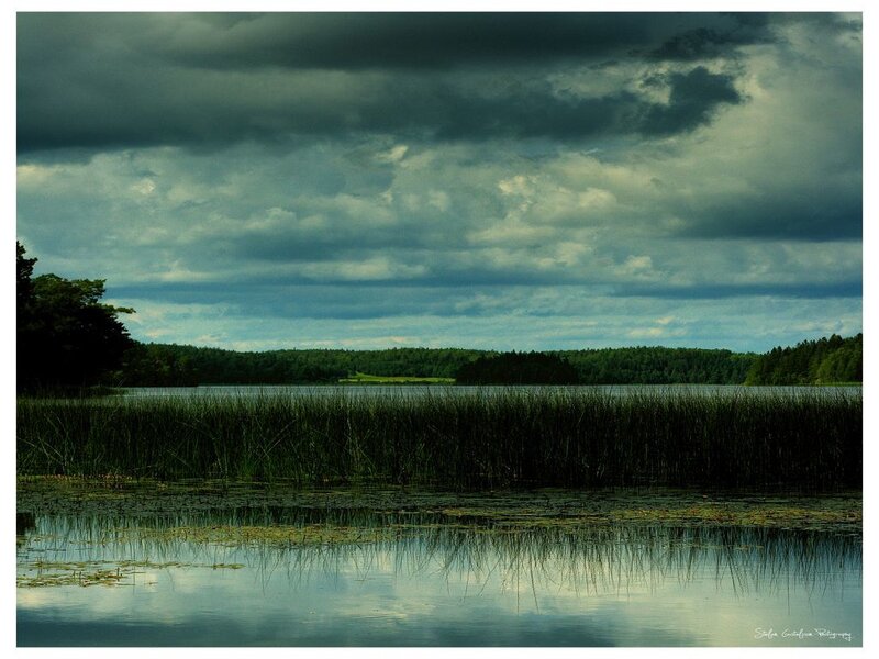 Dark clouds over a tranquil lake