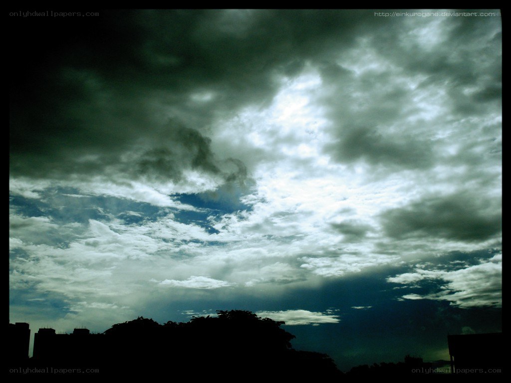 dark clouds over city skyline