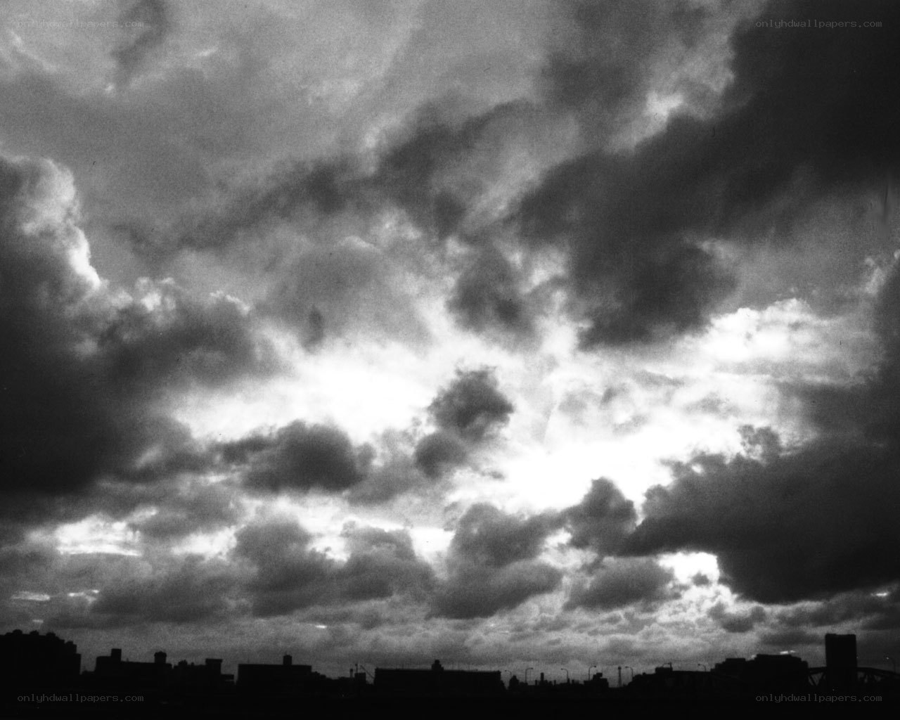 Dark clouds over city skyline
