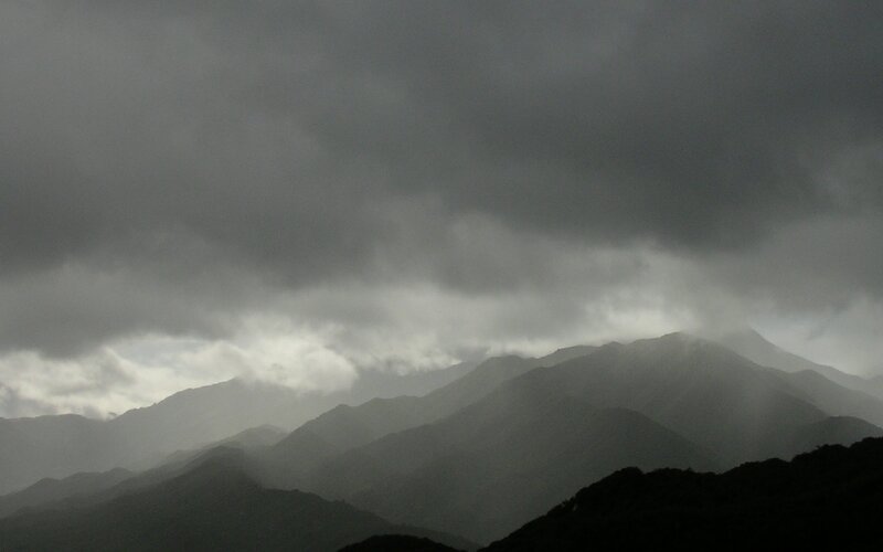 Dark clouds over mountain range