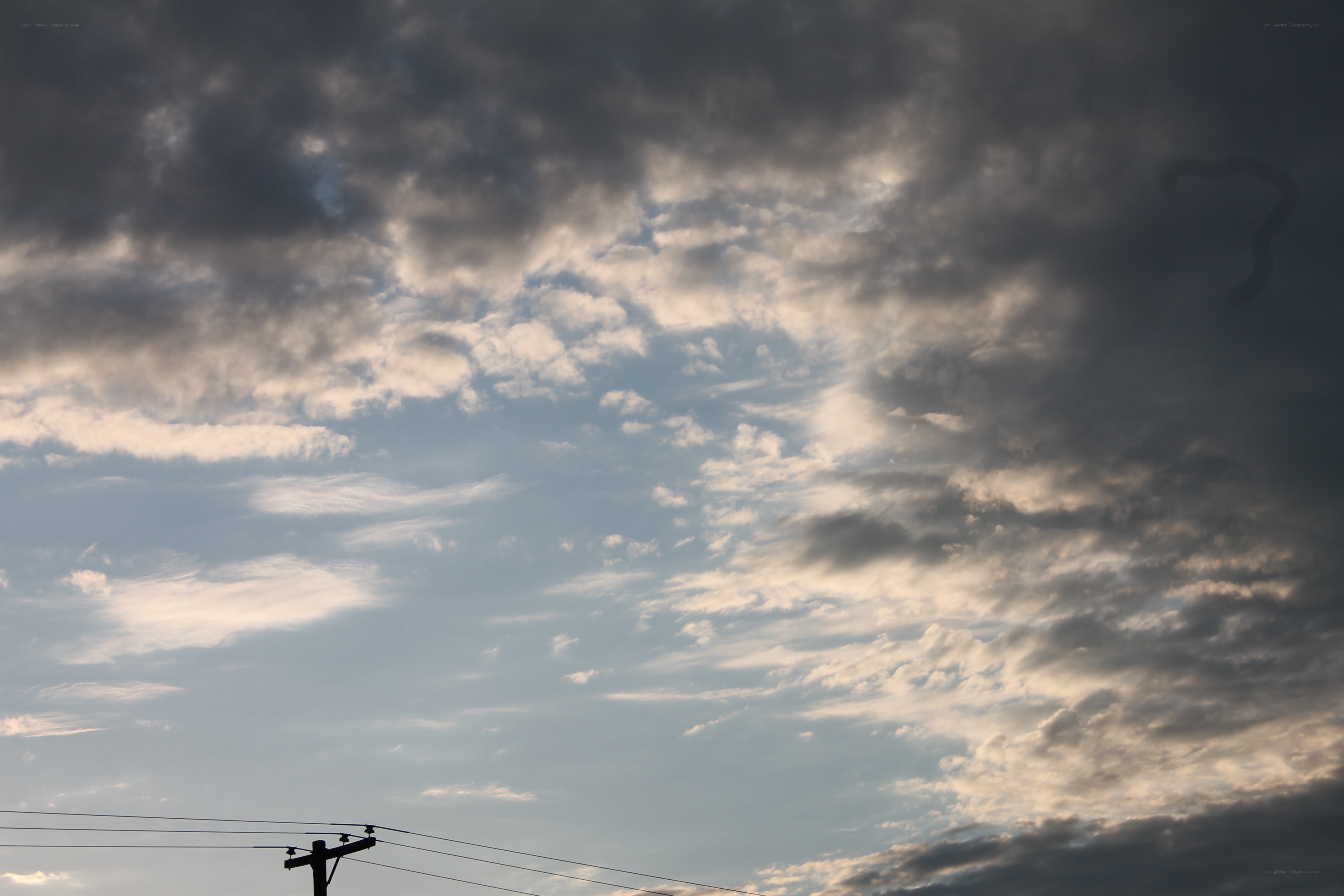 dark clouds over power lines