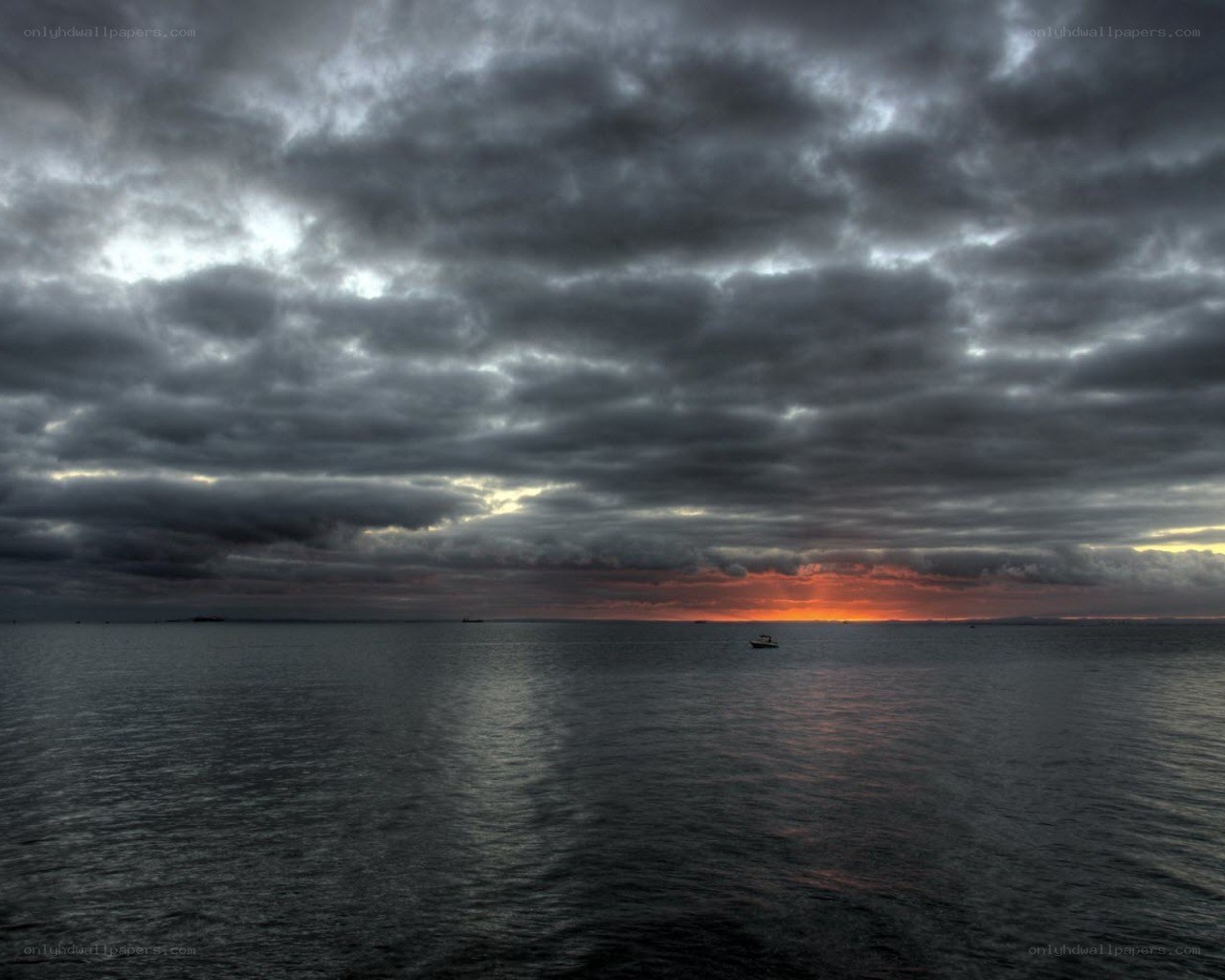 Dark clouds over the sea at sunset