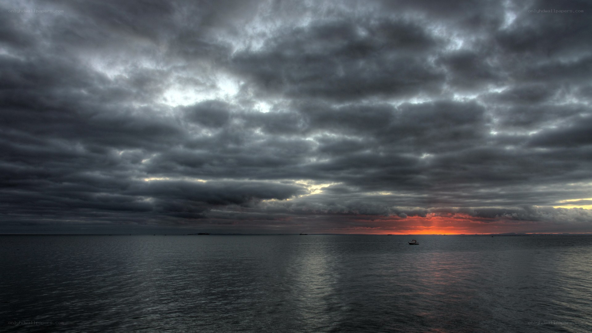 Dark clouds over the sea at sunset