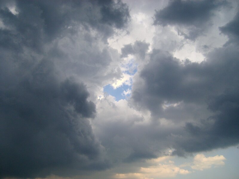 dark clouds with blue sky peeking through