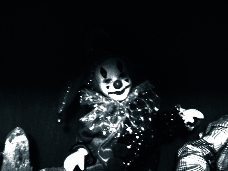 dark clown doll in black and white