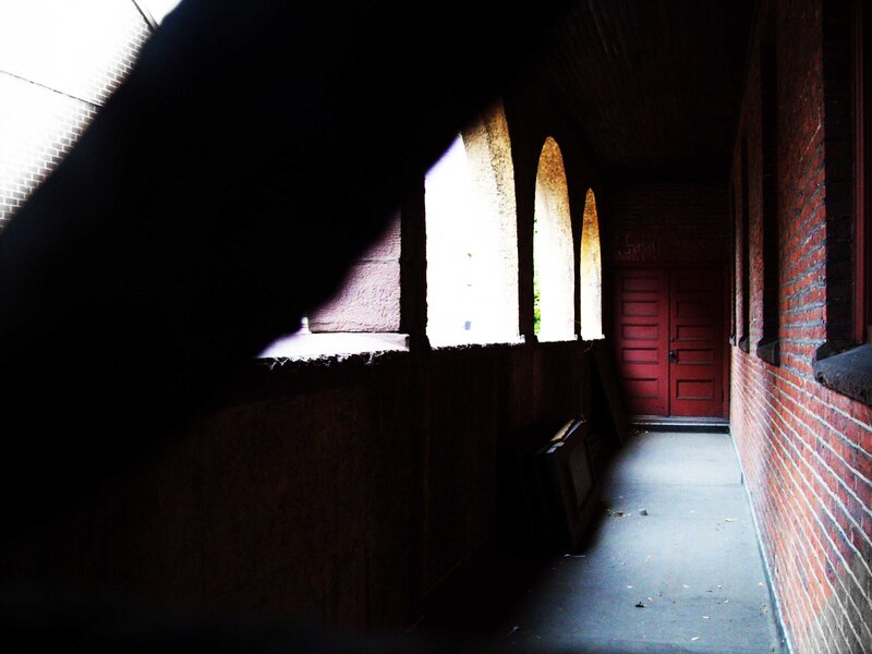 dark corridor with red door