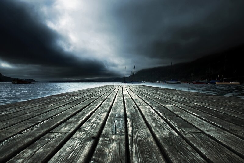 Dark dock under stormy sky