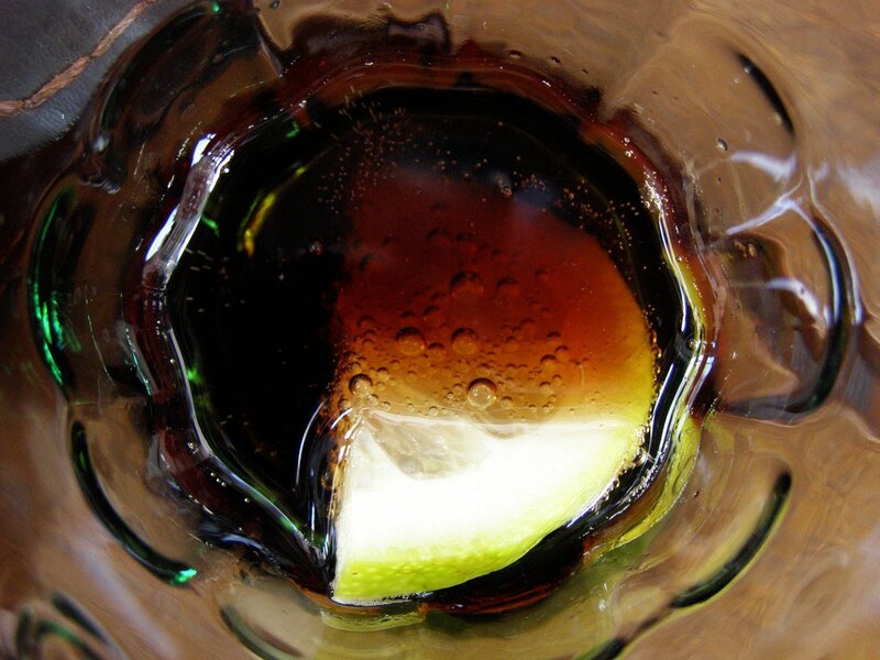 dark drink with lime slice