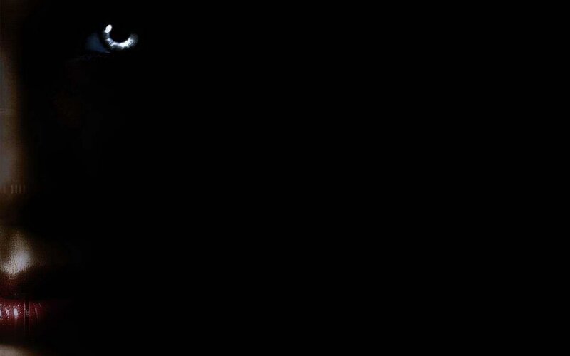 dark face with glowing eye