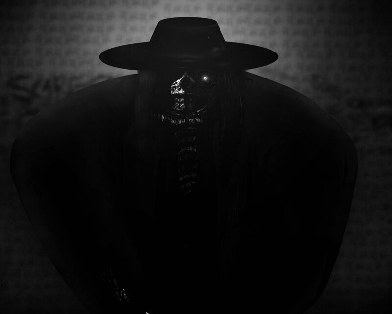 dark figure in a hat