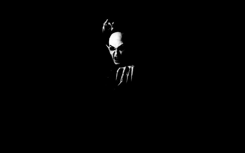 dark figure with sharp teeth