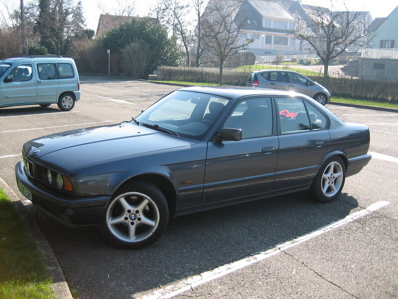 Dark gray BMW parked in lot