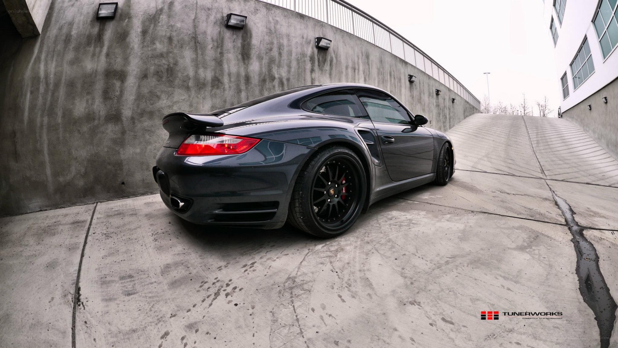 dark gray porsche on concrete ramp