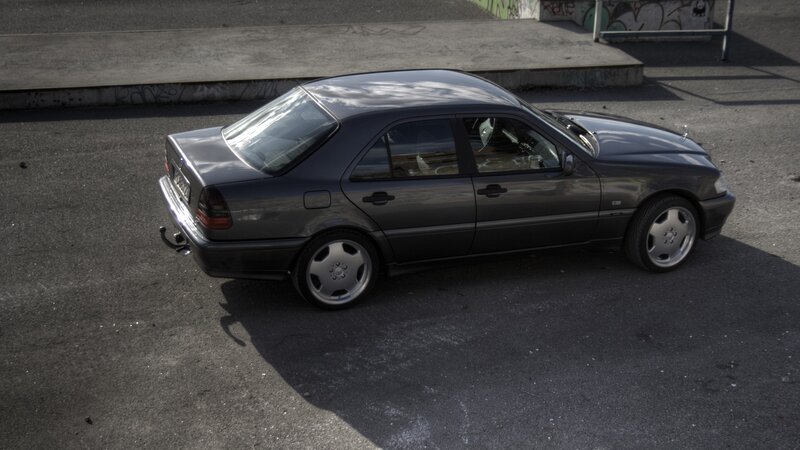 dark gray sedan parked on asphalt